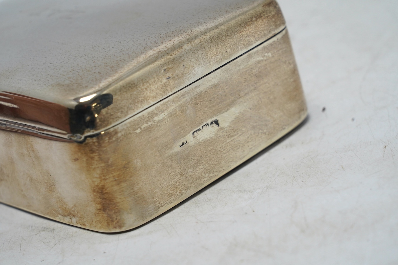 A George V? silver mounted cigarette box, marks rubbed, 13.4cm. Condition - poor to fair